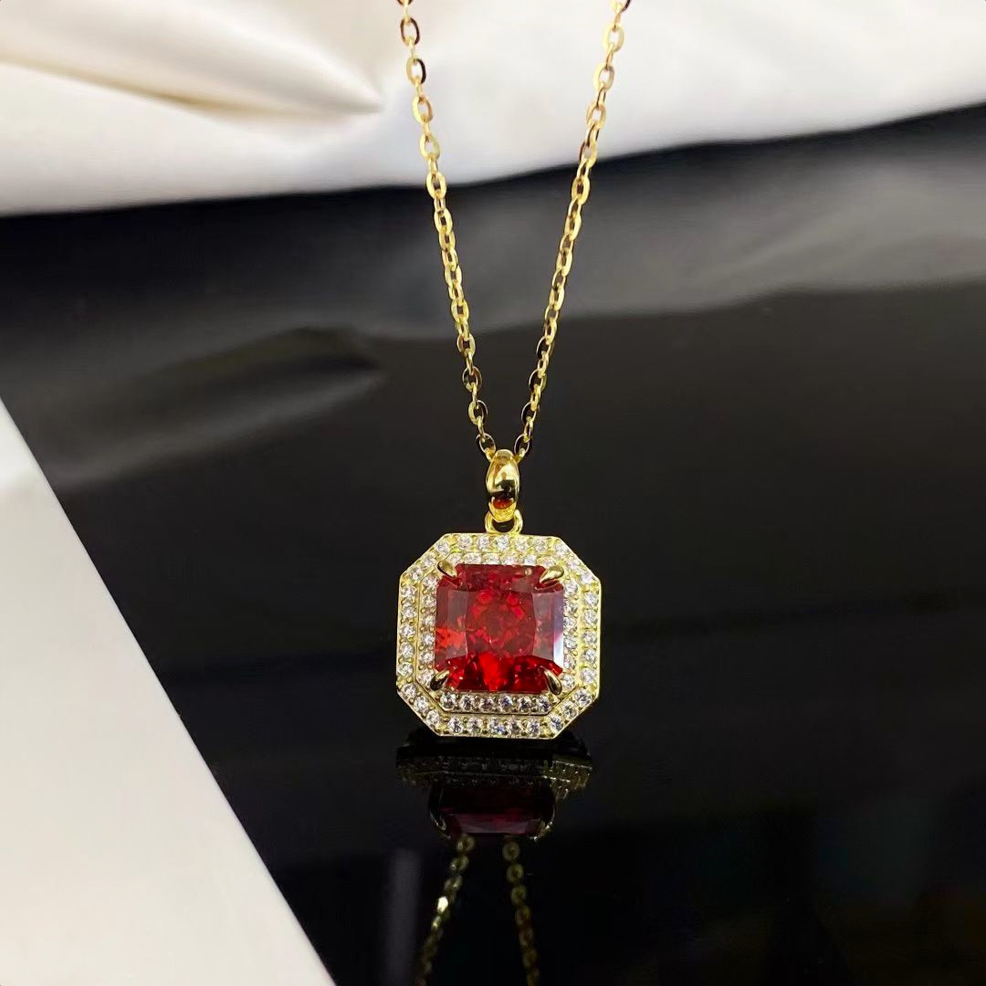 This stunning sterling silver necklace features a captivating red nano crystal, celebrated for its exceptional brilliance and vibrant color consistency. Encased in a decorative lace work gold-plated frame adorned with sparkling cubic zirconia, this piece radiates luxury and elegance, making it a timeless addition to any jewelry collection.