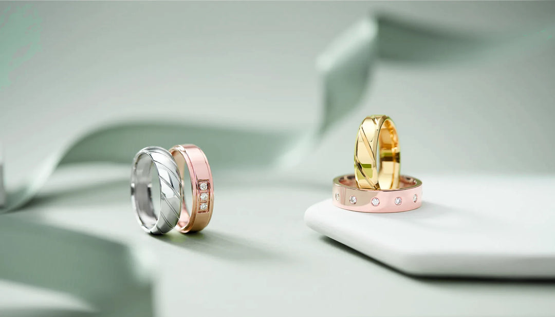 four beautiful men's wedding bands in rose gold, white gold, and yellow gold, set with lab grown diamonds and crafted from sustainable 100% recycled metals