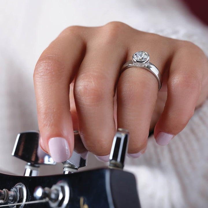 One and a Half Carat Round Brilliant Bezel Moissanite Engagement Ring With Hidden Halo Accents