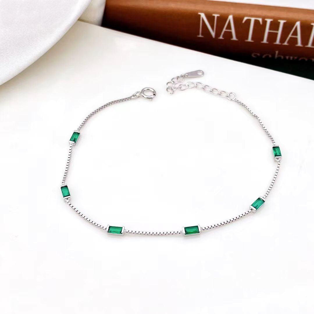 Add a touch of modern elegance to your look with our Emerald Elegance Sterling Silver Bracelet, a piece that seamlessly combines contemporary style with timeless charm