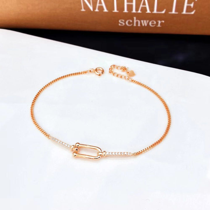 This stylish sterling silver bracelet features a modern geometric design adorned with sparkling cubic zirconia stones. The rose gold plating adds a warm, elegant touch and helps prevent tarnishing, ensuring long-lasting beauty.