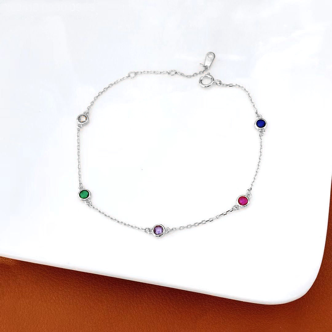 Add a splash of colour to your jewellery collection with this exquisite sterling silver bracelet, featuring a delicate chain adorned with vibrant multi-coloured gemstones. Each gemstone is carefully set to showcase its unique brilliance, creating a playful yet sophisticated look.