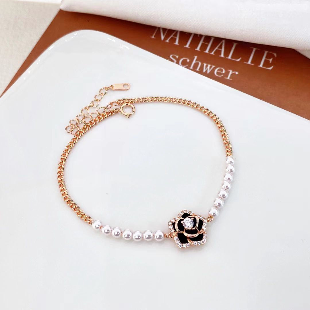 Discover the perfect blend of classic and contemporary style. Ideal as a thoughtful gift or a personal treat, the Timeless Elegance Pearl and Black Rose CZ Bracelet is a timeless addition to any jewellery collection.