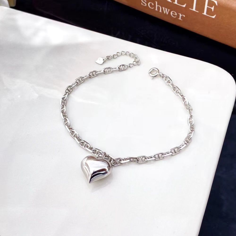 Embrace contemporary elegance with this chic heart charm bracelet. Crafted entirely from premium sterling silver, this bracelet features a stylish chain design with a single, polished heart charm. The sophisticated look and versatile design make it a perfect accessory for any occasion.