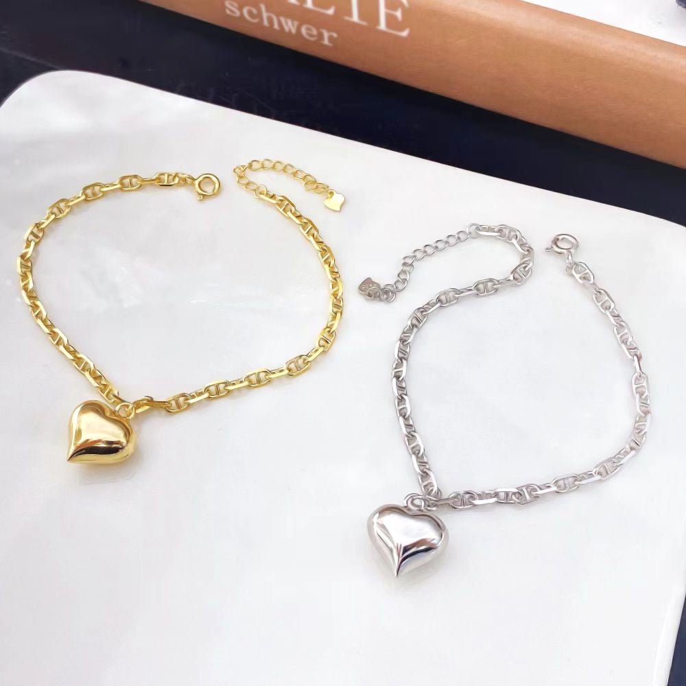 Embrace contemporary elegance with this chic heart charm bracelet. Crafted entirely from premium sterling silver, this bracelet features a stylish chain design with a single, polished heart charm. The sophisticated look and versatile design make it a perfect accessory for any occasion.