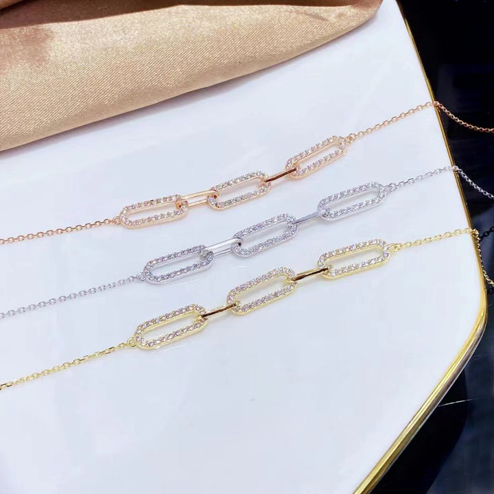 This stylish sterling silver bracelet features a modern link design adorned with sparkling cubic zirconia stones. The yellow gold plating adds a luxurious touch and helps prevent tarnishing, ensuring lasting beauty.