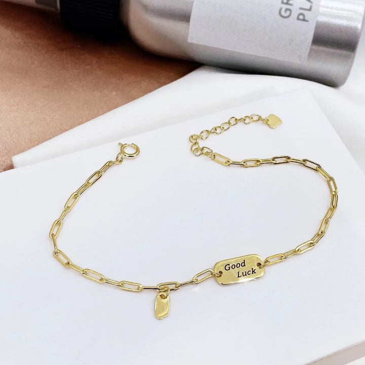 This stylish sterling silver bracelet features a modern link design with a "Good Luck" charm. The yellow gold plating adds a touch of elegance and helps prevent tarnishing, ensuring lasting beauty.
