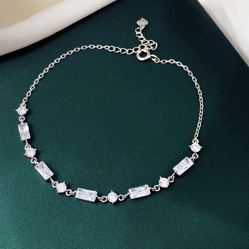 This elegant sterling silver bracelet features alternating baguette and round-cut cubic zirconia stones, creating a sophisticated and timeless look. The rhodium plating adds a sleek, polished finish and helps prevent tarnishing, ensuring lasting beauty.