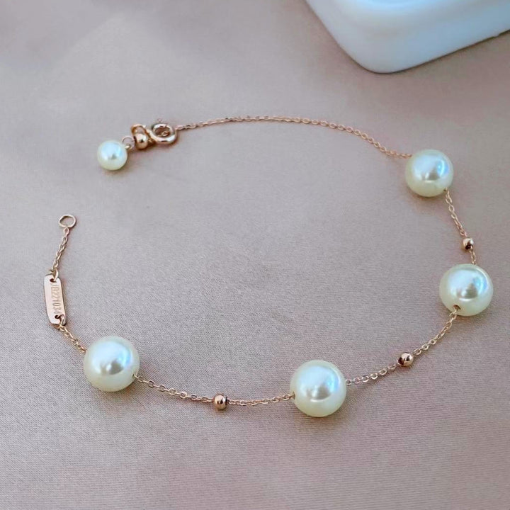 This elegant sterling silver bracelet features lustrous shell pearls set along a delicate chain. The rose gold plating adds a warm, sophisticated touch and helps prevent tarnishing, ensuring lasting beauty.