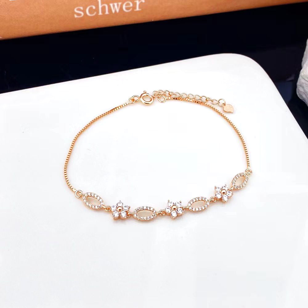 This beautiful sterling silver bracelet features a combination of oval and floral designs adorned with sparkling cubic zirconia stones. The rose gold plating adds a warm, elegant touch and helps prevent tarnishing, ensuring lasting beauty.