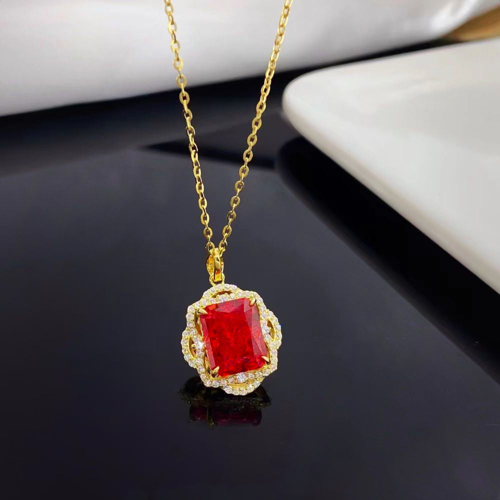 This stunning sterling silver necklace features a captivating red nano crystal, celebrated for its exceptional brilliance and vibrant color consistency. Encased in a decorative lace work gold-plated frame adorned with sparkling cubic zirconia, this piece radiates luxury and elegance, making it a timeless addition to any jewelry collection.