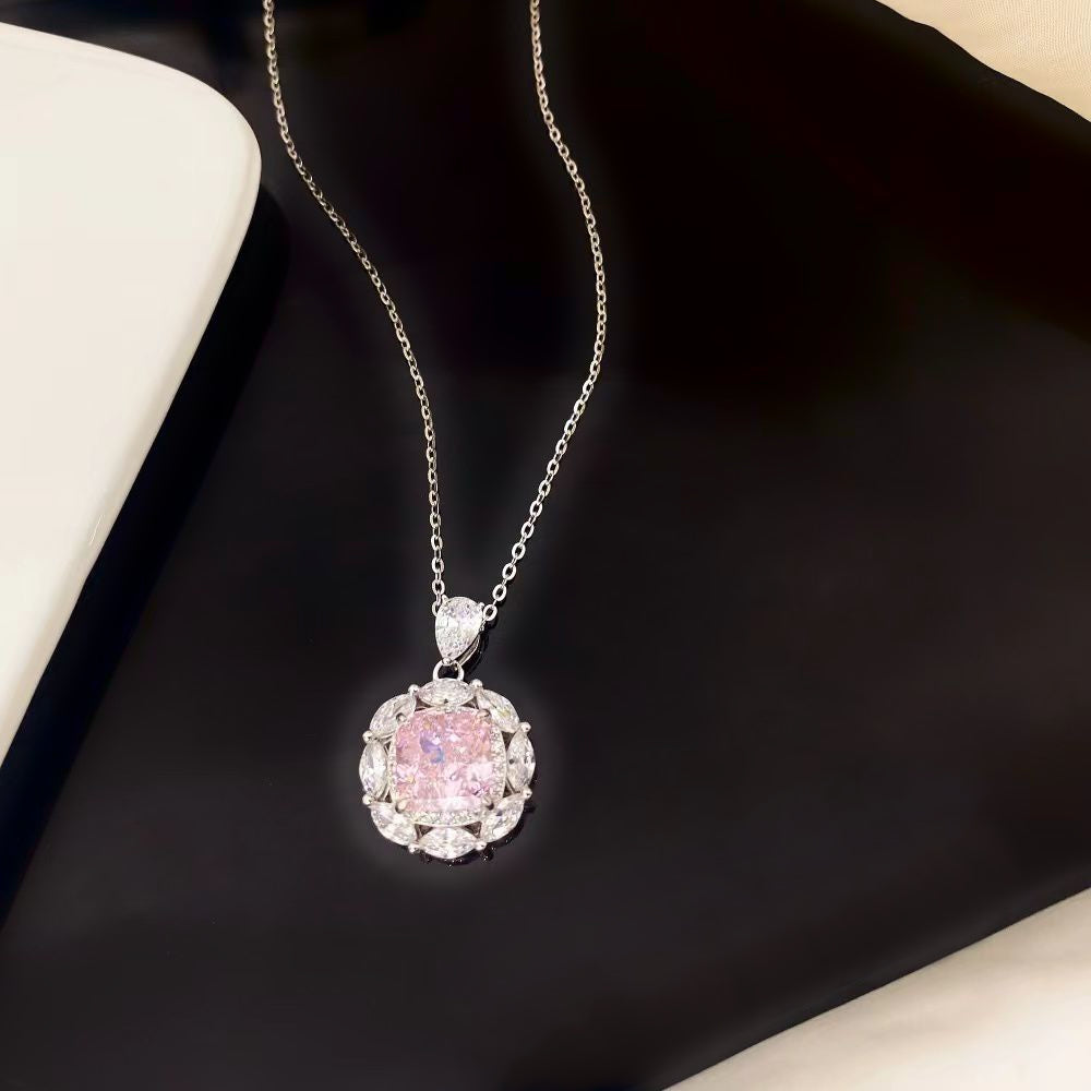 This elegant sterling silver necklace showcases a stunning pink nano crystal, admired for its vibrant hue and exceptional sparkle. The round pendant is gracefully framed by marquise-cut cubic zirconia and finished with a sophisticated rhodium plating, making it a timeless piece for any jewellery collection.