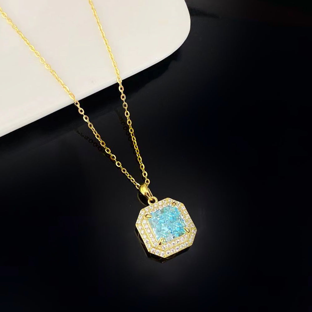 This eye-catching sterling silver necklace features a brilliant aqua blue nano crystal, known for its stunning sparkle and vivid colour. The octagonal pendant is surrounded by shimmering cubic zirconia and finished with a luxurious gold plating, adding an air of sophistication to any outfit.