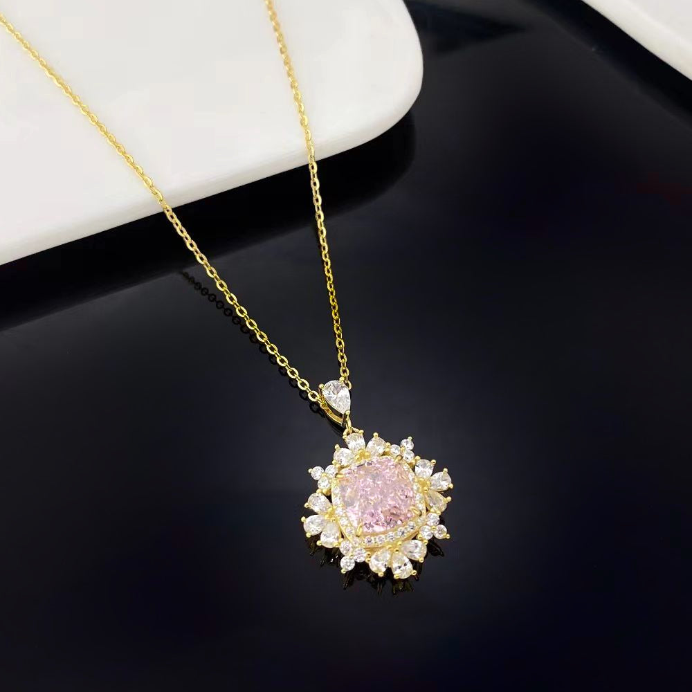 This enchanting sterling silver necklace features a radiant pink nano crystal, celebrated for its exceptional sparkle and vibrant hue. The pendant is surrounded by marquise-cut cubic zirconia and finished with luxurious gold plating, adding a touch of sophistication and beauty to any ensemble.