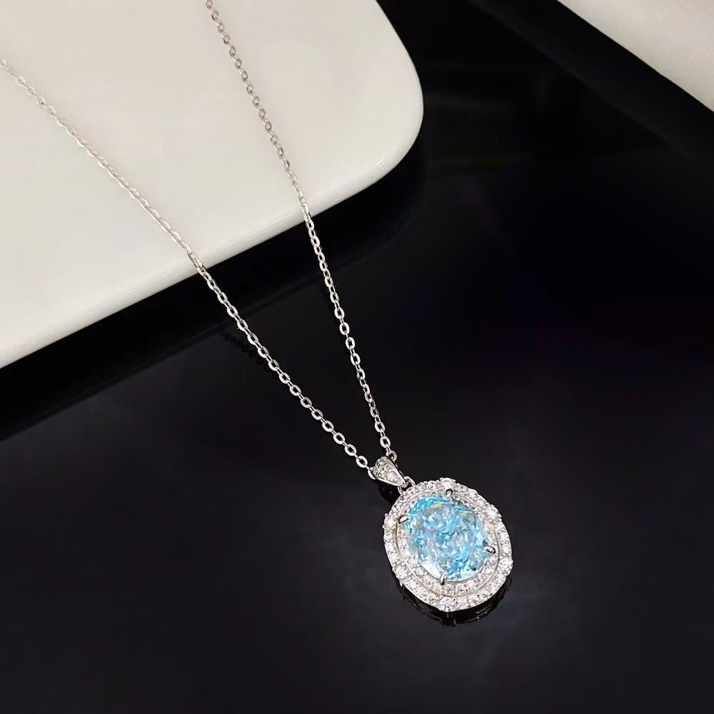 This elegant sterling silver necklace features a stunning blue topaz nano crystal, renowned for its vivid colour and exceptional brilliance. The oval pendant is encircled by dazzling cubic zirconia and finished with a sophisticated rhodium plating, making it a standout piece for any jewellery collection.